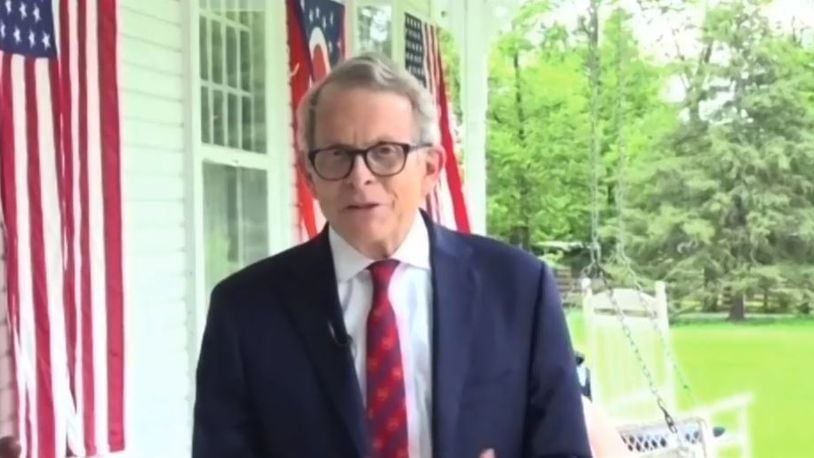 Gov. Mike DeWine speaks during a videoconference from the front porch of his home in Cedarville after his positive coronavirus test on Aug. 6. Protesters danced outside his Cedarville home on Nov. 16 in response to restrictions the governor has implemented as a result of the pandemic.