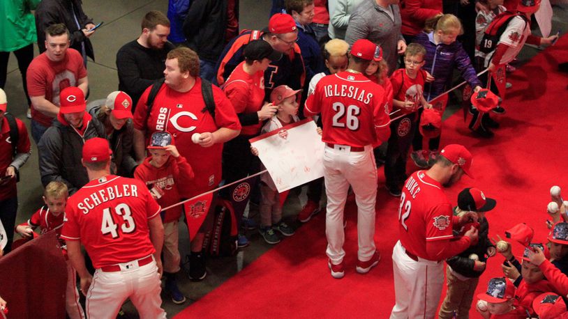The Cincinnati Reds sign autographs as they walk the red carpet on Kids Day at Great American Ball Park on Saturday, March 30, 2019, in Cincinnati. David Jablonski/Staff