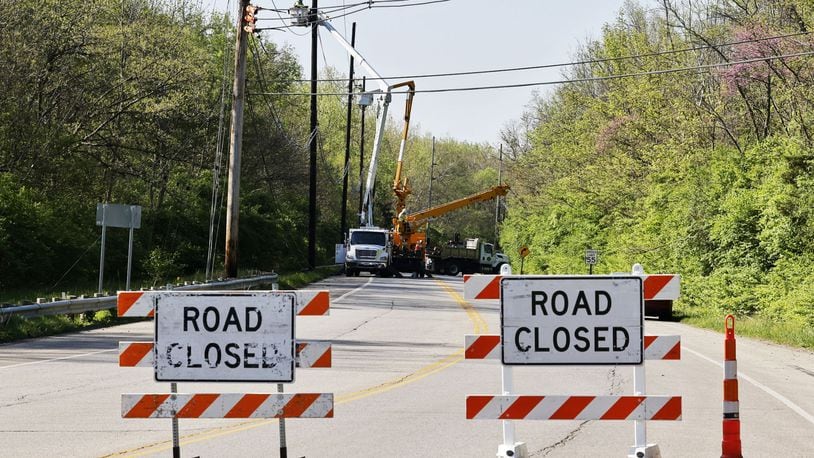 Hamilton-Cleves Road (Ohio 128) is closed today for repairs to utility poles and lines damaged in a crash Saturday night. Nick Graham/STAFF