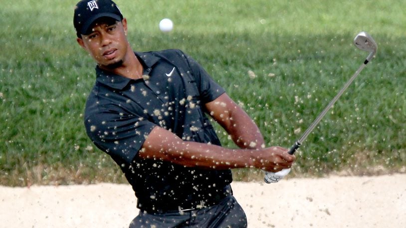 Tiger Woods practices on a bunker at Firestone Country Club in Akron, OH, Tuesday, August 2, 2011. Woods, coming off injuries and 11-weeks away from playing, is preparing for this week’s WGC-Bridgestone Invitational. (Marvin Fong / The Plain Dealer)