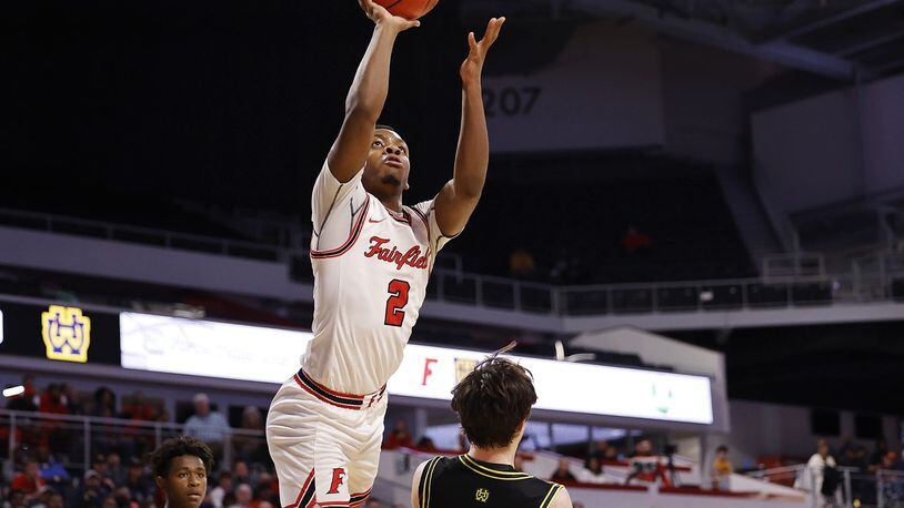 Fairfield's Deshawne Crim goes to the hoop over Walnut Hills guard Max Poynter during their Division I District final Sunday, March 6, 2022 at Fifth Third Arena on the University of Cincinnati campus. Fairfield won 55-52. NICK GRAHAM/STAFF