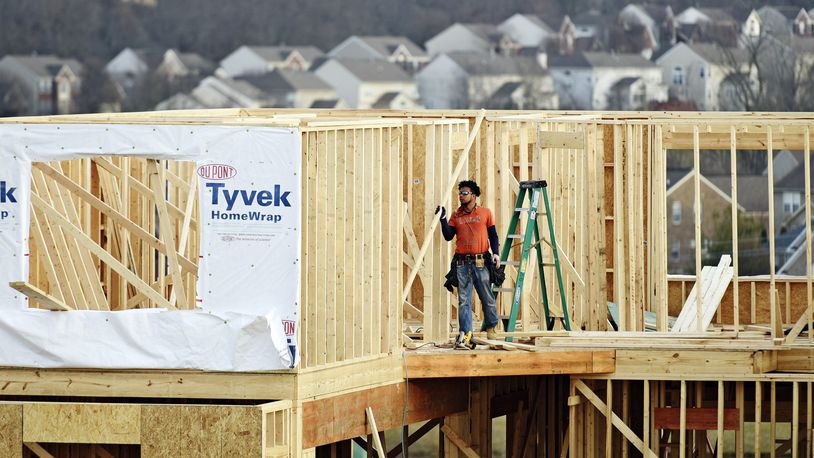 A crew works on construction of a new home on Elm Leaf Trail Monday, Feb. 20, in Liberty Twp. NICK GRAHAM/STAFF