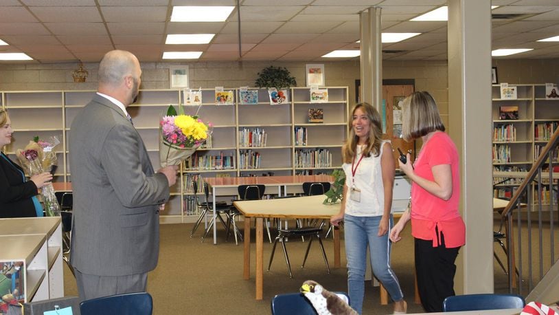 Audrey Young, counselor for Freedom Elementary, is surprised with flowers and news delivered by Principal Lance Green on her winning Lakota s annual Educators of Excellence award for grades pre-K through 6th.