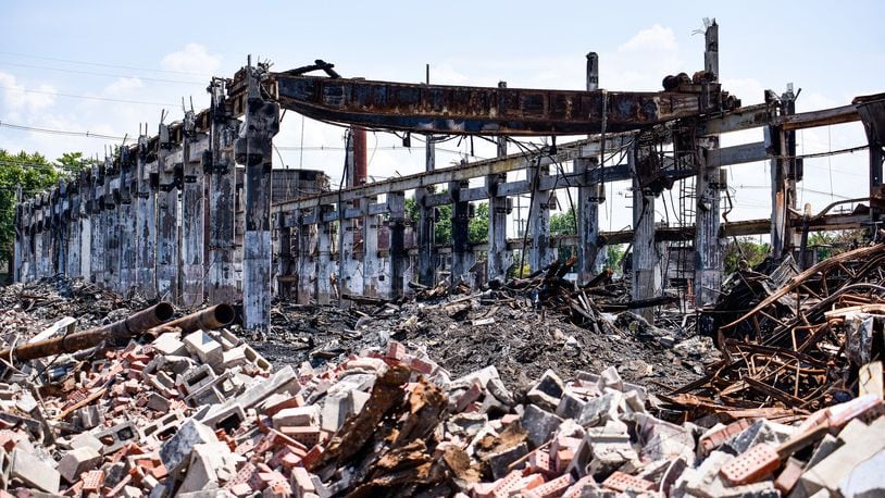 Crews from Vickers Demolition work to dismantle what is left a week after a massive warehouse fire on Laurel Avenue Wednesday, July 31 in Hamilton. The fire started just before 5 a.m. Thursday, July 25, 2019. NICK GRAHAM / STAFF