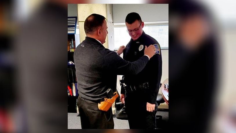 Middletown Police Detective Jon Rawlins,left, at the swearing in of his son, Ryun as a reserve police officer with the department. MIDDLETOWN DIVISION OF POLICE