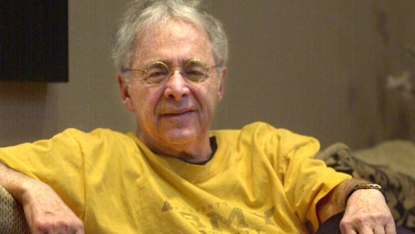 FILE - In this Dec. 20, 2002, file photo, Chuck Barris, the man behind TV's "The Dating Game," poses in the lobby of his apartment in New York. Game show impresario Barris has died at 87. Barris, the madcap producer of "The Gong Show" and "The Dating Game," died of natural causes Tuesday afternoon, March 21, 2017, at his home in Palisades, New York. (AP Photo/Bebeto Matthews, File)