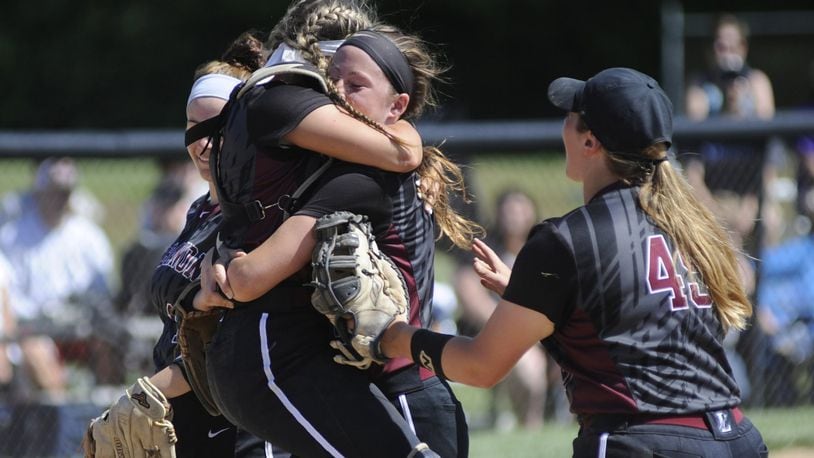 Lebanon catcher Molly Osborne celebrates with pitcher Kat Frank as first baseman Ashleigh Riffle (45) joins in Wednesday after the Warriors defeated Lakota East 6-3 in a Division I regional semifinal at Centerville. MARC PENDLETON/STAFF