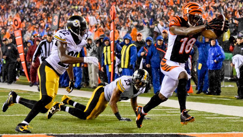Cincinnati Bengals receiver AJ Green makes a catch and runs it in for a touchdown during their18-16 loss to the Pittsburgh Steelers in the AFC wild card playoff game Saturday, Jan. 9 at Paul Brown Stadium in Cincinnati. NICK GRAHAM/STAFF