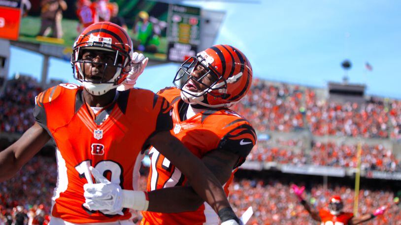 Bengals wide receivers Brandon Tate, left, and Mohamed Sanu celebrate a touchdown catch by Tate against the Chiefs on Sunday, Oct. 4, 2015, at Paul Brown Stadium in Cincinnati. David Jablonski/Staff