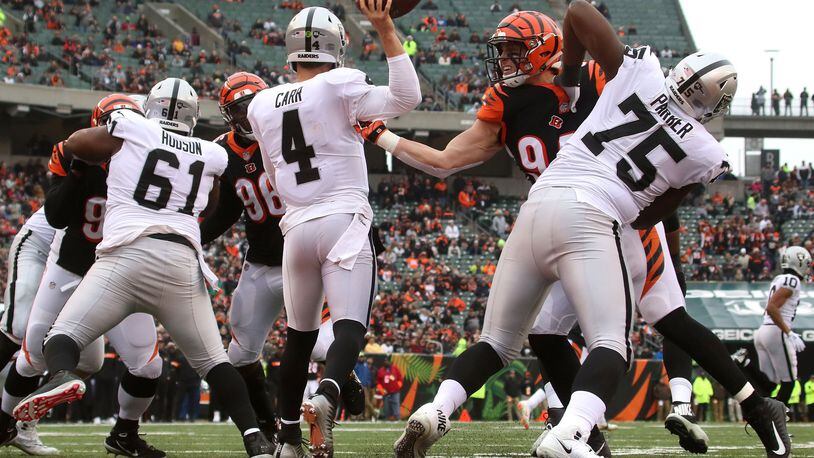 CINCINNATI, OH - DECEMBER 16: Sam Hubbard #94 of the Cincinnati Bengals fights through a block by Brandon Parker #75 of the Oakland Raiders to knock down an attempted pass by Derek Carr #4 during the first quarter at Paul Brown Stadium on December 16, 2018 in Cincinnati, Ohio. (Photo by John Grieshop/Getty Images)