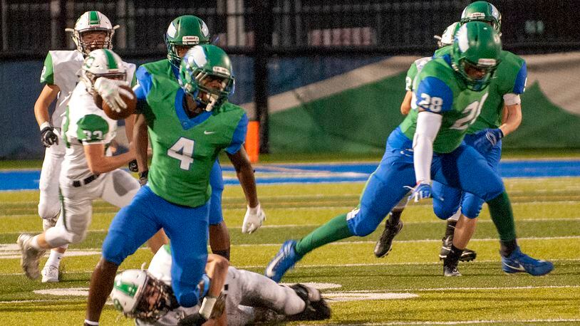 Chaminade Julienne receiver Kenyon Owens breaks a tackle during the first half of Friday night’s game against Hamilton Badin at CJ. Jeff Gilbert/CONTRIBUTED