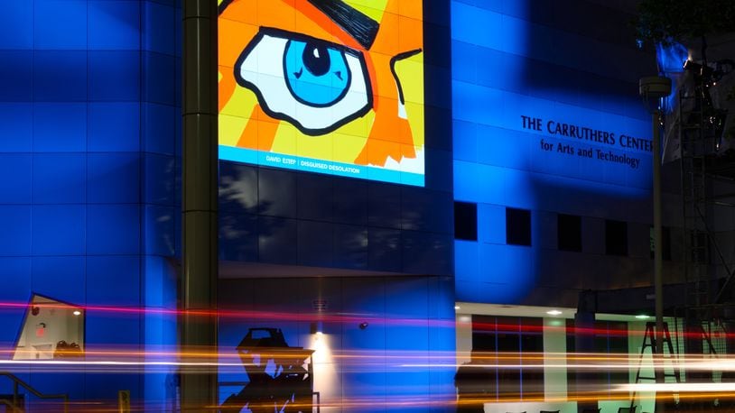 Artwork is projected on the outside of Fitton Center for Creative Arts, which will receive $40,000 through the Ohio Arts Council this year. This piece is by artist David Estep. NICK GRAHAM / STAFF