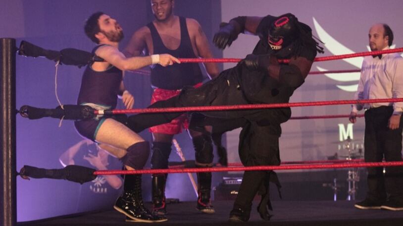 “The Scarecrow” lands a low blow during the finale of a show at Kissimmee’s Manor Pro Wrestling Dinner Theater.  (Photo: C.J. Walker/Palm Beach Post)