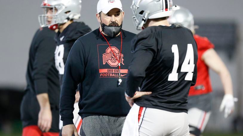 Ohio State coach Ryan Day, left, talks with quarterback Kyle McCord during an NCAA college football practice in Columbus, Ohio, Monday, April 5, 2021. (AP Photo/Paul Vernon)