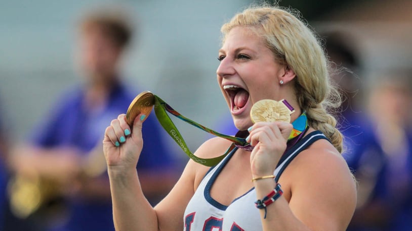 Kayla Harrison, two-time Olympic Gold Medalist in Judo, takes the field with her gold medals before the Middies game Friday, Sept. 9 at Barnitz Stadium in Middletown. NICK GRAHAM/STAFF