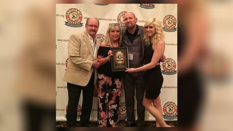 Professional wrestler and wrestling trainer Cody Hawk celebrated his Trainer’s Award in Las Vegas with his parents, to the left, Bo and Carol Myers of Kettering, and wrestler Shawna Reed, who he trains and is his girlfriend. PROVIDED