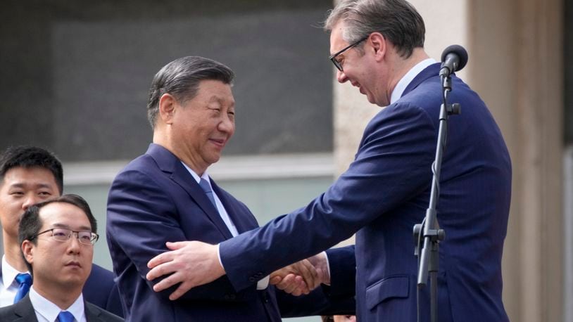 Chinese President Xi Jinping, left, shakes hands with his Serbian counterpart Aleksandar Vucic greet the crowd at the Serbia Palace in Belgrade, Serbia, Wednesday, May 8, 2024. (AP Photo/Darko Bandic)