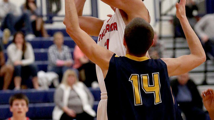 Talawanda’s Andrew O’Donnel puts up a shot over Monroe forward Josh McCready during their game at Talawanda on Dec. 22, 2015. CONTRIBUTED PHOTO BY E.L. HUBBARD