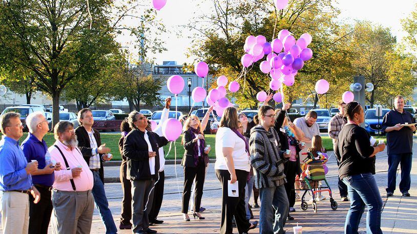 The fourth annual Domestic Violence Awareness Event will take place at 5 p.m. Monday at the Middletown City Building, 1 Donham Plaza. Pictured are participants at the 2014 event releasing balloons in honor of domestic violence victims. FILE/2014