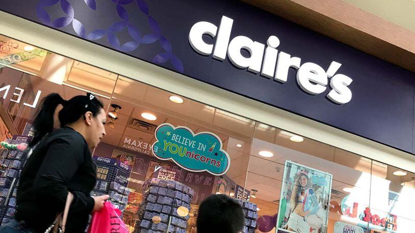 People walk by a Claire's store at the Northgate Mall on March 19, 2018 in San Rafael, California. The teen jewelry chain store is recalling three types of makeup over asbestos contamination fears.