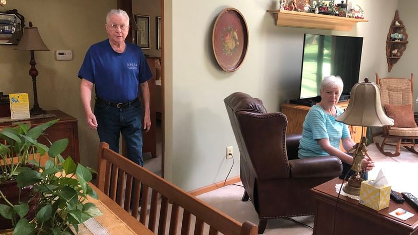 As part of his rehabilitation, Dave Campbell walks around his Lebanon home as his wife, Bev, keeps a close eye. Recovering from the coronavirus, Campbell walks about three fourths a mile daily. RICK McCRABB/STAFF