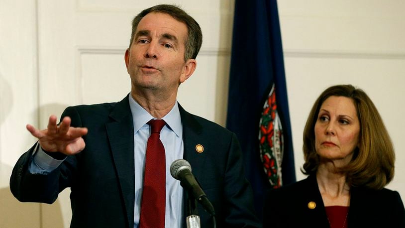 In this Feb. 2, 2019 file photo, Virginia Gov. Ralph Northam, left, gestures as his wife, Pam, listens during a news conference in the Governors Mansion at the Capitol in Richmond, Va. (AP Photo/Steve Helber, File)