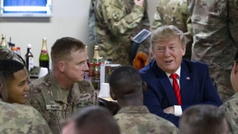 President Donald Trump talks with troops Thursday during his surprise visit to Afghanistan.