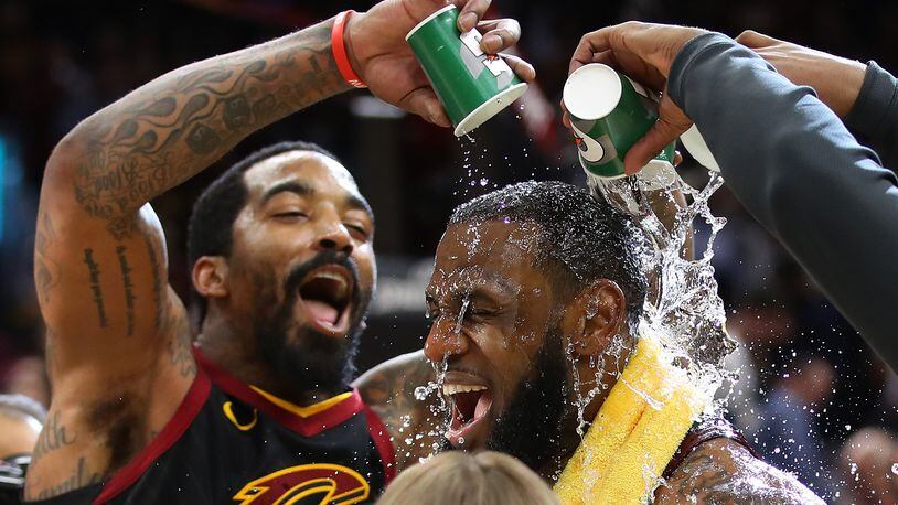 CLEVELAND, OH - APRIL 25: LeBron James #23 of the Cleveland Cavaliers is showered with water by JR Smith #5 while being interviewed after a 98-95 win over the Indiana Pacers in Game Five of the Eastern Conference Quarterfinals during the 2018 NBA Playoffs at Quicken Loans Arena on April 25, 2018 in Cleveland, Ohio. (Photo by Gregory Shamus/Getty Images)