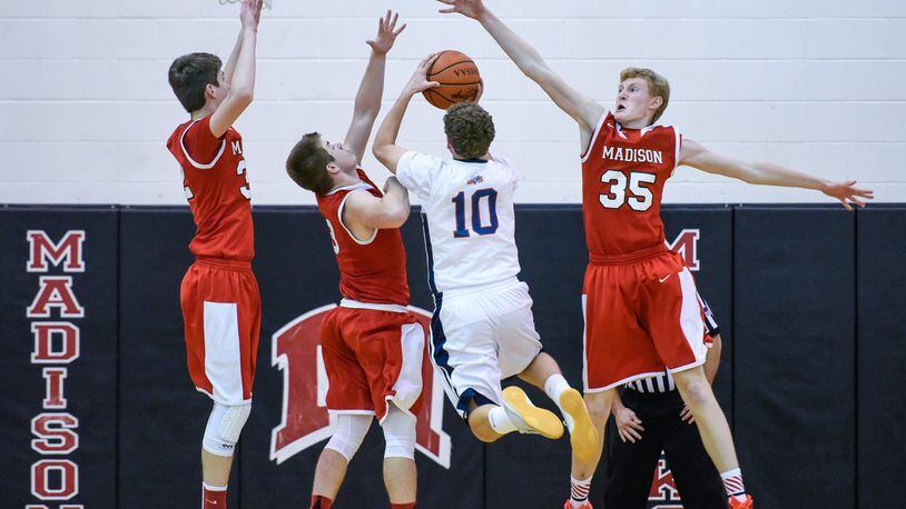 Miami Valley’s Alec Martin takes a shot while being defended by Madison’s Grant Whisman (32), Mason Whiteman (3) and Kevin Duritsch (35) during their game in the Brian Cook Classic on Thursday night at Madison. NICK GRAHAM/STAFF