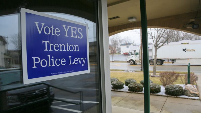 Signs outside the Trenton Police Station at City Hall support the first-time permanent 5.25-mill levy for police on the March 15 ballot. The funds would allow the city to hire as many as five police officers over time, according to Police Chief Arthur Scott, and replace or upgrade equipment like police cruisers, some of which are more than 10 years old. GREG LYNCH / STAFF