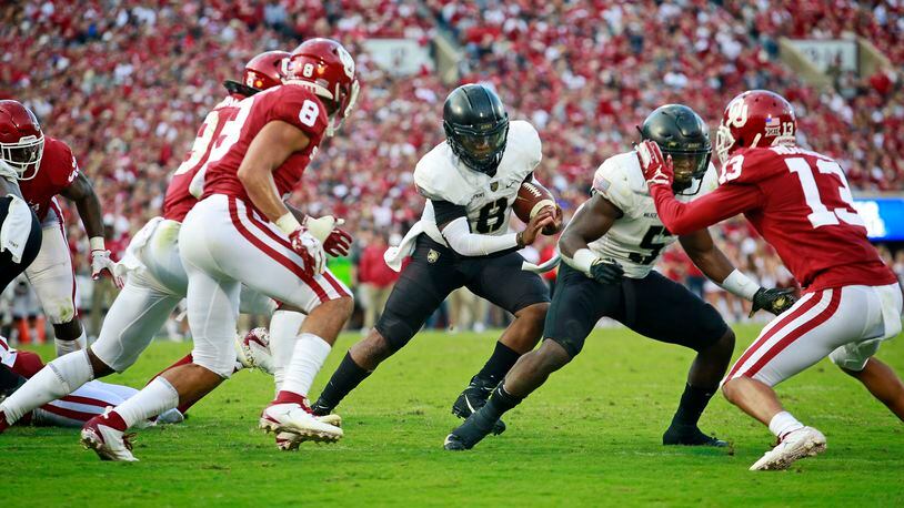 Quarterback Kelvin Hopkins Jr. #8 of the Army Black Knights looks for a hole in the Oklahoma Sooners defense at Gaylord Family Oklahoma Memorial Stadium on September 22, 2018 in Norman, Oklahoma. (Photo by Brett Deering/Getty Images)