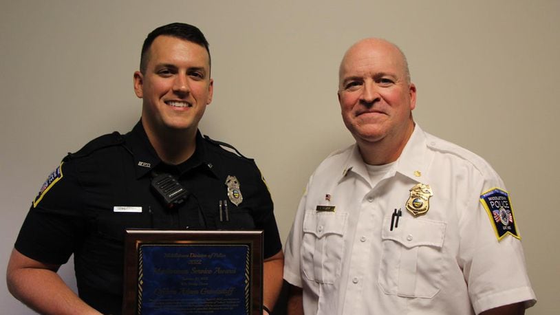 Middletown Police Officer Adam Grindstaff, left,  with Maj. Eric Crank, received a Meritorious Service Award last week for life-saving measure he gave to a crash victim. MIDDLETOWN DIVISION OF POLICE