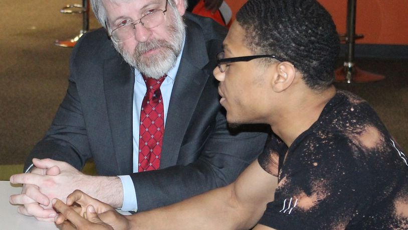 State Superintendent of Public Instruction Paolo DeMaria (left) listens to Darius Watkins discuss the impact of Springfield’s Career ConnectED on his education. JEFF GUERINI/STAFF