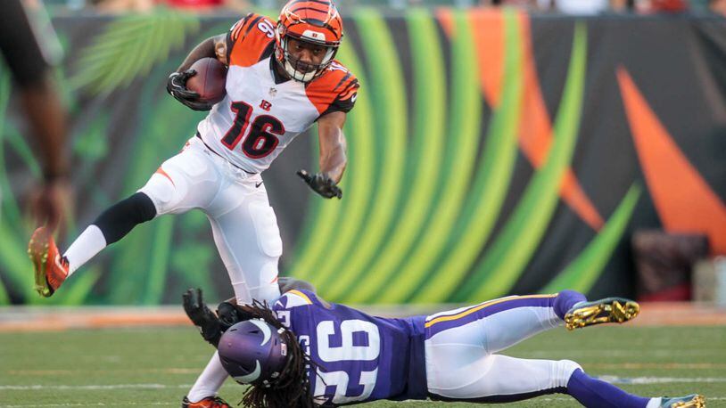 Cincinnati Bengals wide receiver Cody Core tries to avoid a tackle by Minnesota Vikings cornerback Trae Waynes during the first quarter of their first pre-season game Friday, Aug. 12 at Paul Brown Stadium in Cincinnati. NICK GRAHAM/STAFF