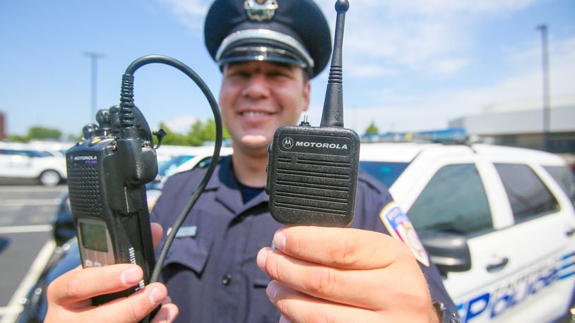 Fairfield Police officer Scott Webb displays his radio outside the police station, Wednesday, Aug. 2, 2017. Butler County officials and police and fire departments across the county are looking at a $19.2 million price tag to replace parts of the 800 MHz communications systems, including the radios first responders carry.GREG LYNCH / STAFF