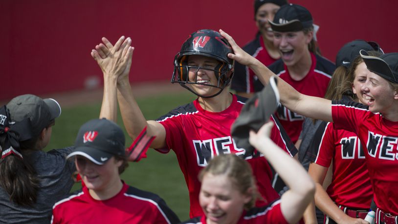 Lakota West’s Allie Cummins celebrates with her teammates after hitting a solo home run in the top of the eighth inning May 31 at Firestone Stadium in Akron. The homer gave the Firebirds a 2-1 win over Perrysburg in a Division I state semifinal. CONTRIBUTED PHOTO BY PHIL LONG