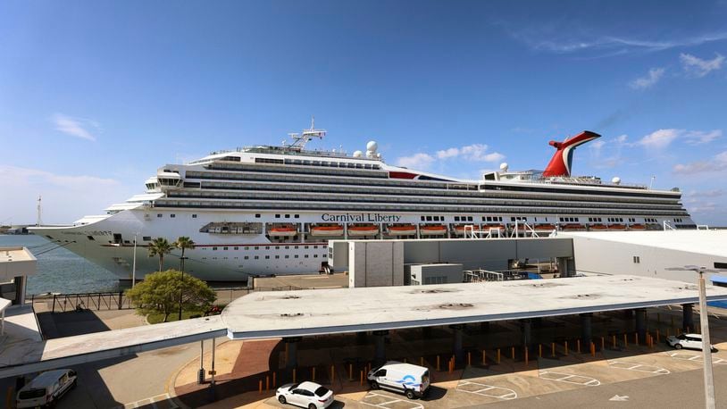 FILE - In this Wednesday, May 12, 2021, file photo, the Carnival Cruise ship "Liberty" is docked at Port Canaveral, Fla., as crew members get vaccinated for COVID-19. Carnival Corp. is still losing money, but it sees a glimmer of hope in stronger bookings for next year. The cruise line company said Friday, Sept. 24, 2021, that it lost $2.8 billion in the third quarter, which ended Aug. 31. (Joe Burbank/Orlando Sentinel via AP, File)
