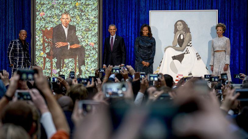 From left, artist Kehinde Wiley, who painted former President Barack Obama’s portrait, former President Barack Obama, former first lady Michelle Obama, and artist Amy Sherald, who painted Michelle Obama’s portrait, stand on stage together during an unveiling ceremony at the Smithsonian’s National Portrait Gallery, Monday, Feb. 12, 2018, in Washington. (AP Photo/Andrew Harnik)