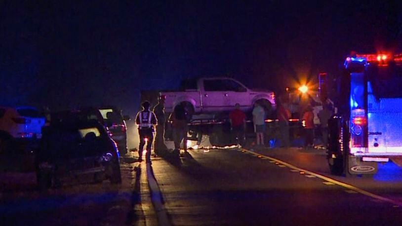 In this image made from video, people gather around a pickup truck on a flatbed truck at the scene of an accident on U.S. Highway 80 in Chunky, Miss., late Monday, Oct. 31, 2016. A vehicle struck the flat-bed trailer carrying adults and children who were dressed up for Halloween, killing three people and injuring several others, authorities said. (WTO via AP)