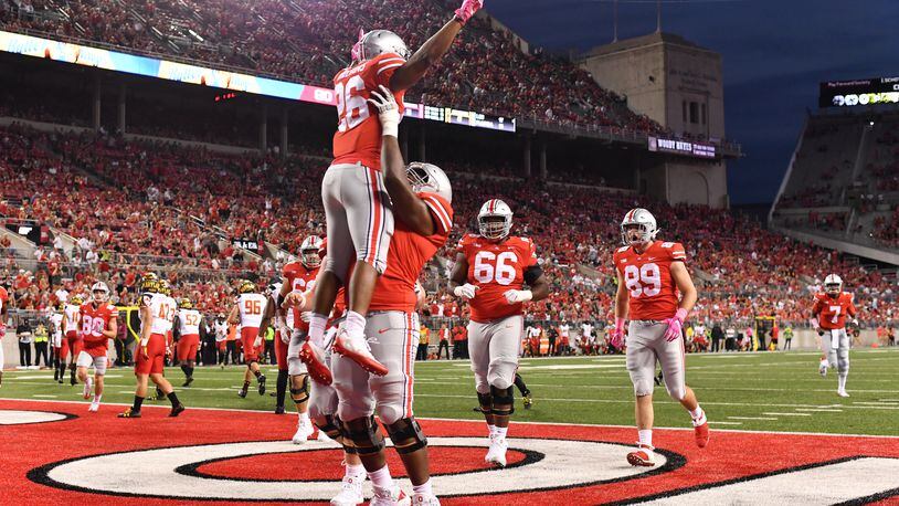 COLUMBUS, OH - OCTOBER 7: Antonio Williams #26 of the Ohio State Buckeyes celebrates in the end zone with Thayer Munford #75 of the Ohio State Buckeyes after scoring on an eight-yard touchdown run in the fourth quarter against the Maryland Terrapins at Ohio Stadium on October 7, 2017 in Columbus, Ohio. Ohio State defeated Maryland 62.14. (Photo by Jamie Sabau/Getty Images)