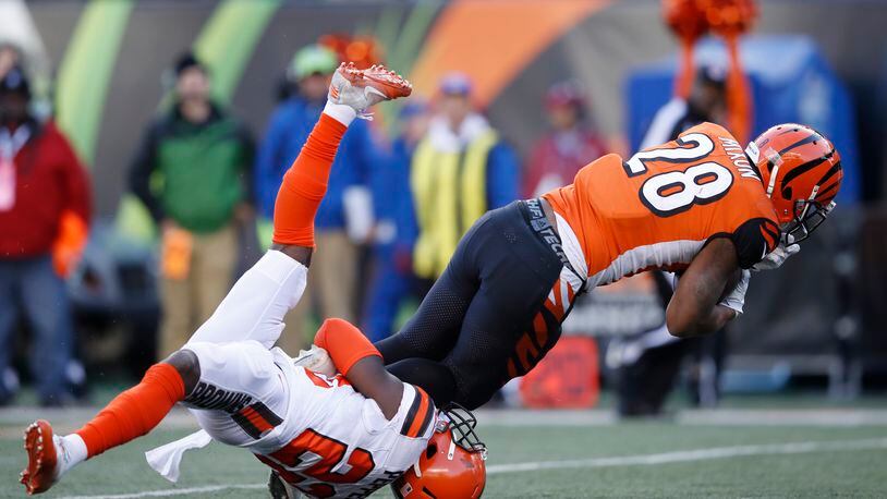 Joe Mixon #28 of the Cincinnati Bengals runs over Jabrill Peppers #22 of the Cleveland Browns in the second half of a game at Paul Brown Stadium on November 26, 2017 in Cincinnati, Ohio. The Bengals won 30-16. (Photo by Joe Robbins/Getty Images)