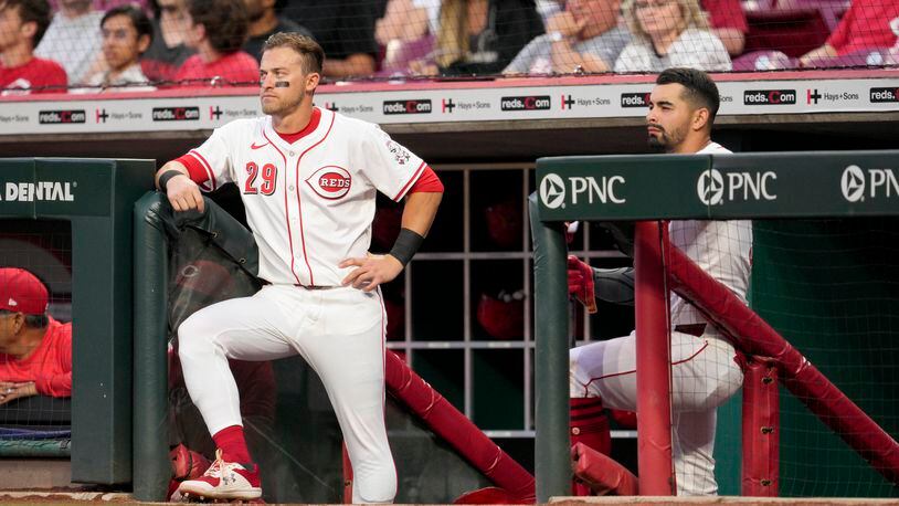Cincinnati Reds' TJ Friedl (29) and Christian Encarnacion-Strand stand in the dugout during the sixth inning of a baseball game against the Arizona Diamondbacks Tuesday, May 7, 2024, in Cincinnati. (AP Photo/Jeff Dean)
