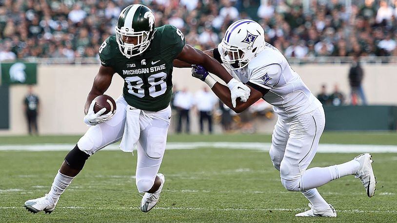 EAST LANSING, MI - SEPTEMBER 02: Monty Madaris #88 of the Michigan State Spartans avoids a tackle by Thomas Brown #6 of the Furman Paladins during the first half of a game at Spartan Stadium on September 2, 2016 in East Lansing, Michigan. (Photo by Stacy Revere/Getty Images)