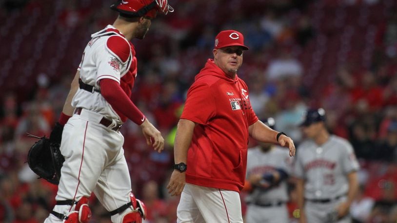 Reds pitch coach Derek Johnson, right, talks to catch Curt Casali after a mound visit during a game against the Astros on Monday, June 17, 2019, at Great American Ball Park in Cincinnati. David Jablonski/Staff