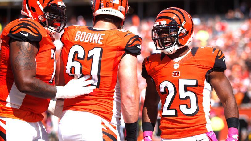 Bengals running back Giovani Bernard, right, celebrates a touchdown with center Russell Bodine (61) and Andre Smith against the Chiefs on Sunday, Oct. 4, 2015, at Paul Brown Stadium in Cincinnati. David Jablonski/Staff