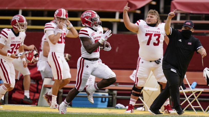 Louisiana-Lafayette running back Chris Smith, center, returns a kickoff 95-yards for a touchdown during the first half of an NCAA college football game against Iowa State, Saturday, Sept. 12, 2020, in Ames, Iowa. (AP Photo/Charlie Neibergall)