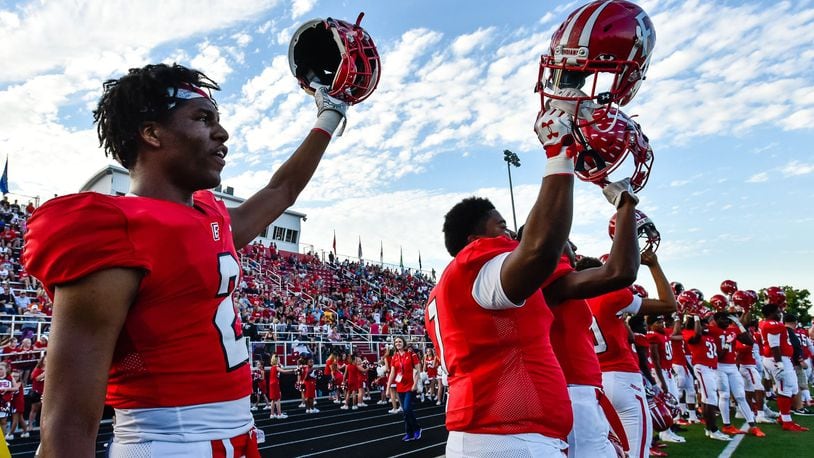 Fairfield’s Sawiaha Ellis (left) holds up his helmet as their game against Lakota West gets started Sept. 14 at Fairfield Stadium. The host Indians won 37-3. NICK GRAHAM/STAFF