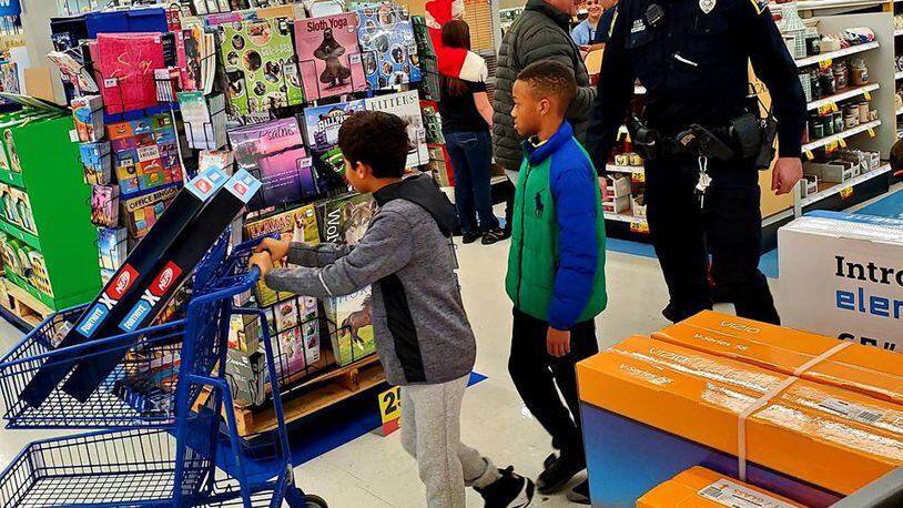 About 70 local children were allowed to spend $100 on “whatever they wanted” for Christmas during the annual Mike Davis Shop with a Cop program in Middletown. SUBMITTED PHOTO