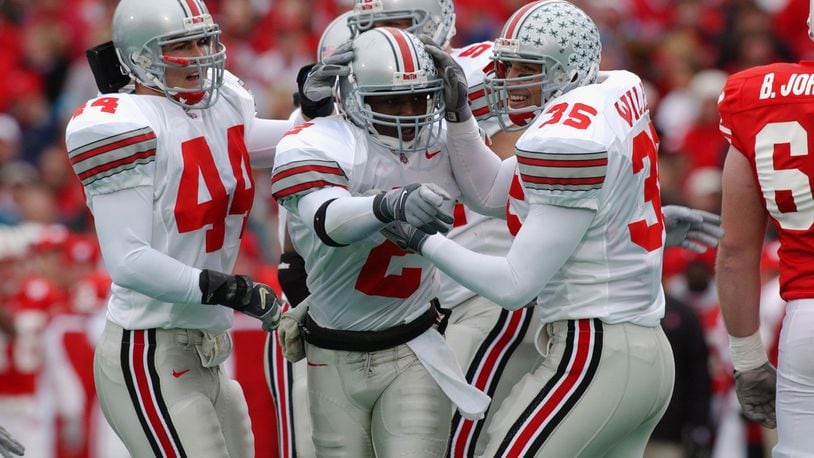 MADISON, WI - OCTOBER 19:  Safety Mike Doss #2 of Ohio State celebrates a fumble recovery with linebacker teammates Matt Wilhelm #35 and Robert Reynolds #44 during the NCAA football game against Wisconsin at Camp Randall Stadium in Madison, Wisconsin on October 19, 2002.  The Ohio State Buckeyes defeated the Wisconsin Badgers 14 - 19.  (Photo by Jonathan Daniel /Getty Images)