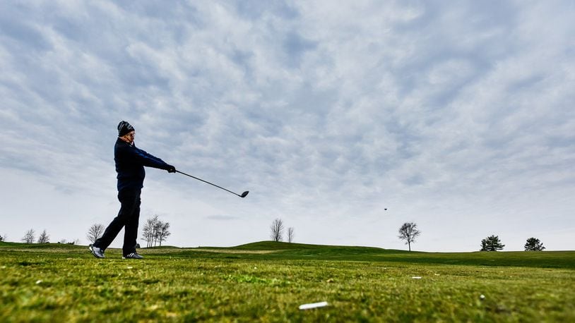 Tom Brandner tees off as he plays a round of golf at Indian Ridge Golf Club Tuesday, March 24, 2020 in Hanover Township. The golf course was not officially open to the public Tuesday but some members have been utilizing the course. When they do open they will be trying to minimize the spread of coronavirus by only allowing one person per cart and closing the concession area. NICK GRAHAM / STAFF